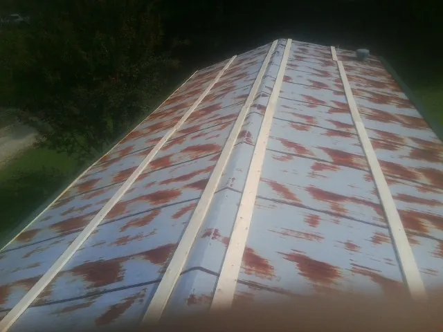 Rusted metal roof panels with new wood purlins before replacement — Storm Damage Roof Repair in Meridian by Roofing Brothers